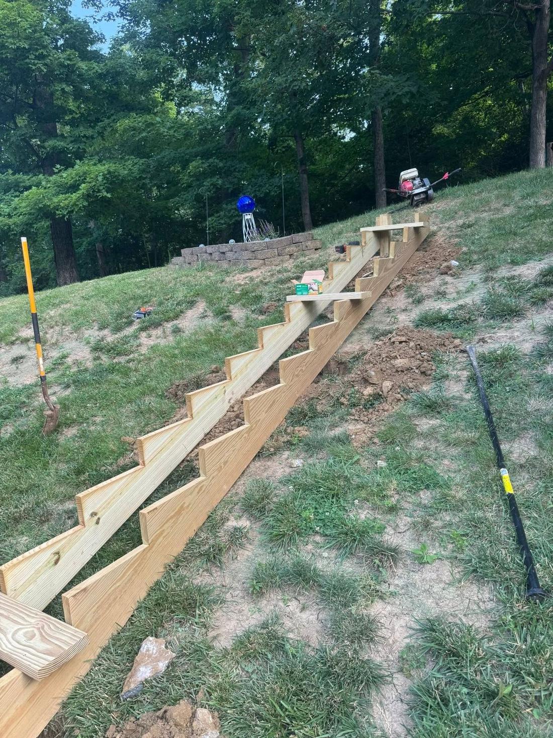 Timber retaining wall built into a graded slope