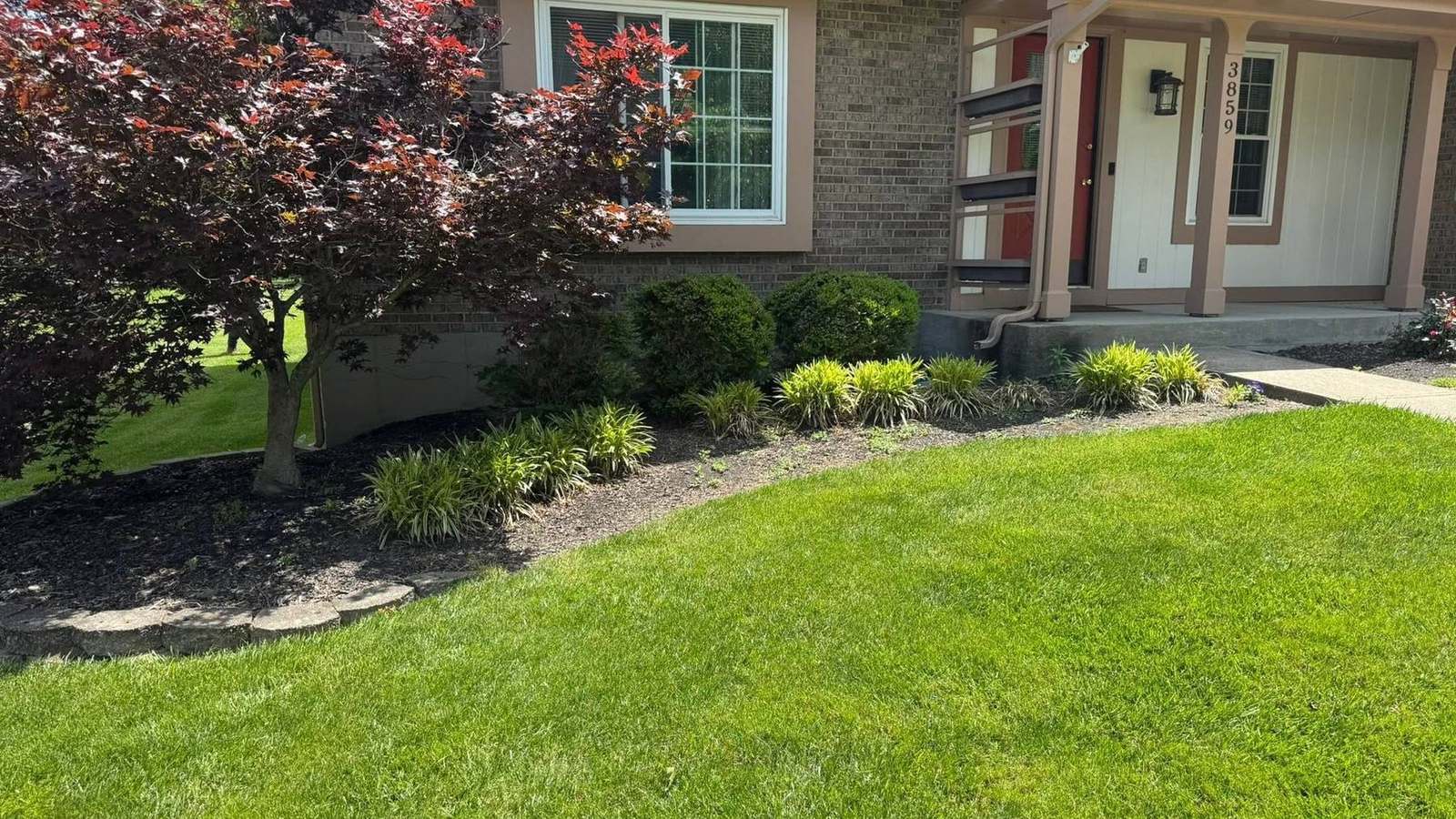 Front landscaping and mulched beds by Barth Contracting